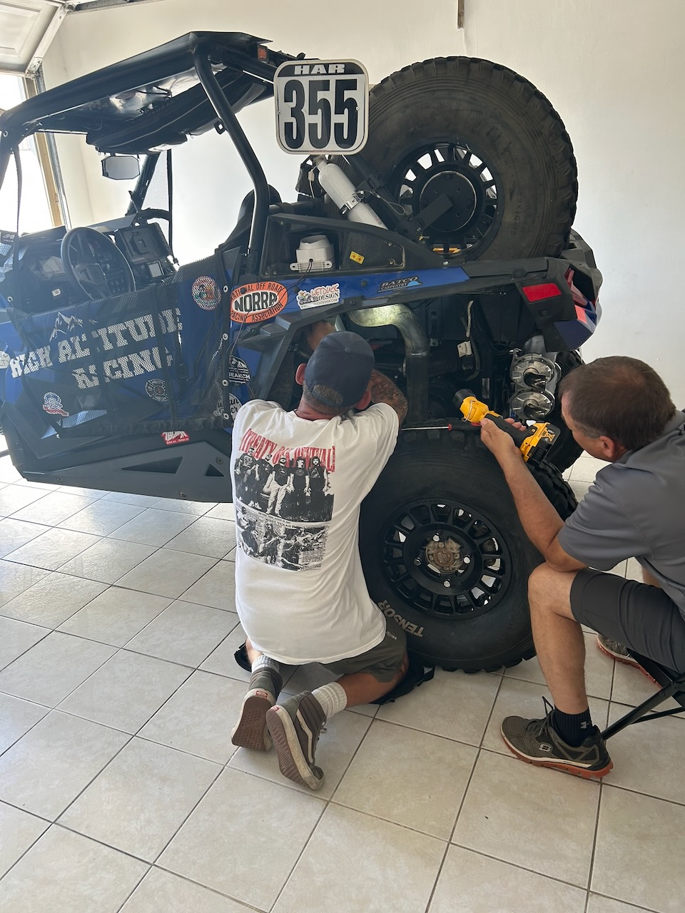 Team member working on the CVT cooling system of race car 355